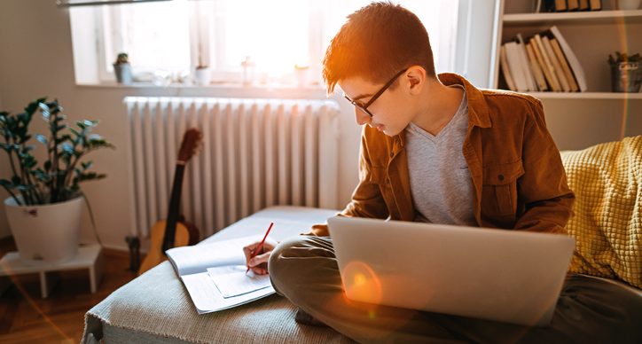 Teenage boy completing his JavaScript activity