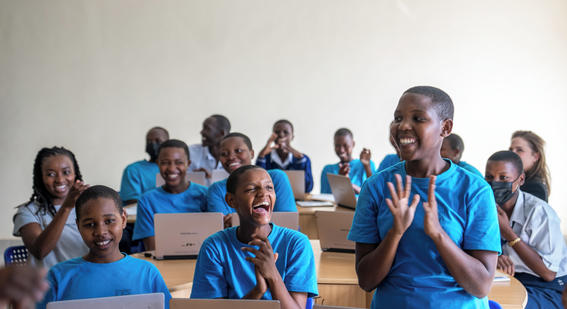 students applauding in a classroom in Rwanda