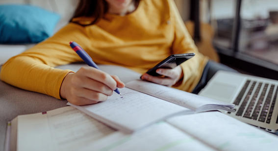 A female student is using AI chatbot on phone to help with her homework