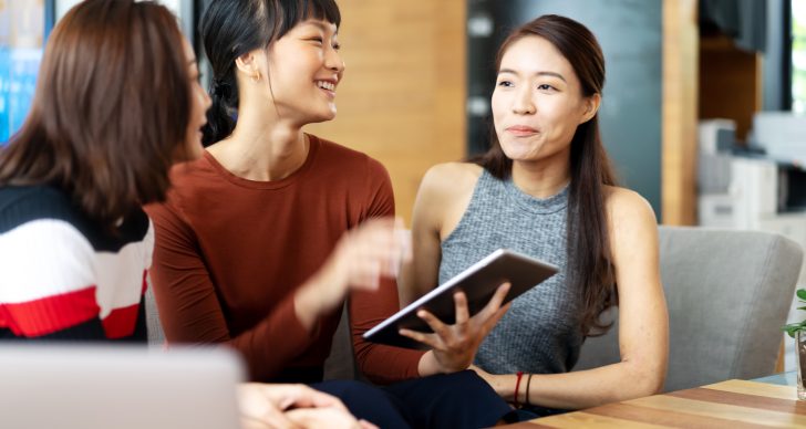 chinese girls talking with digital tablet